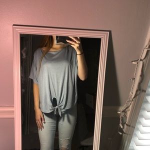 Blue gray top with tie in front.